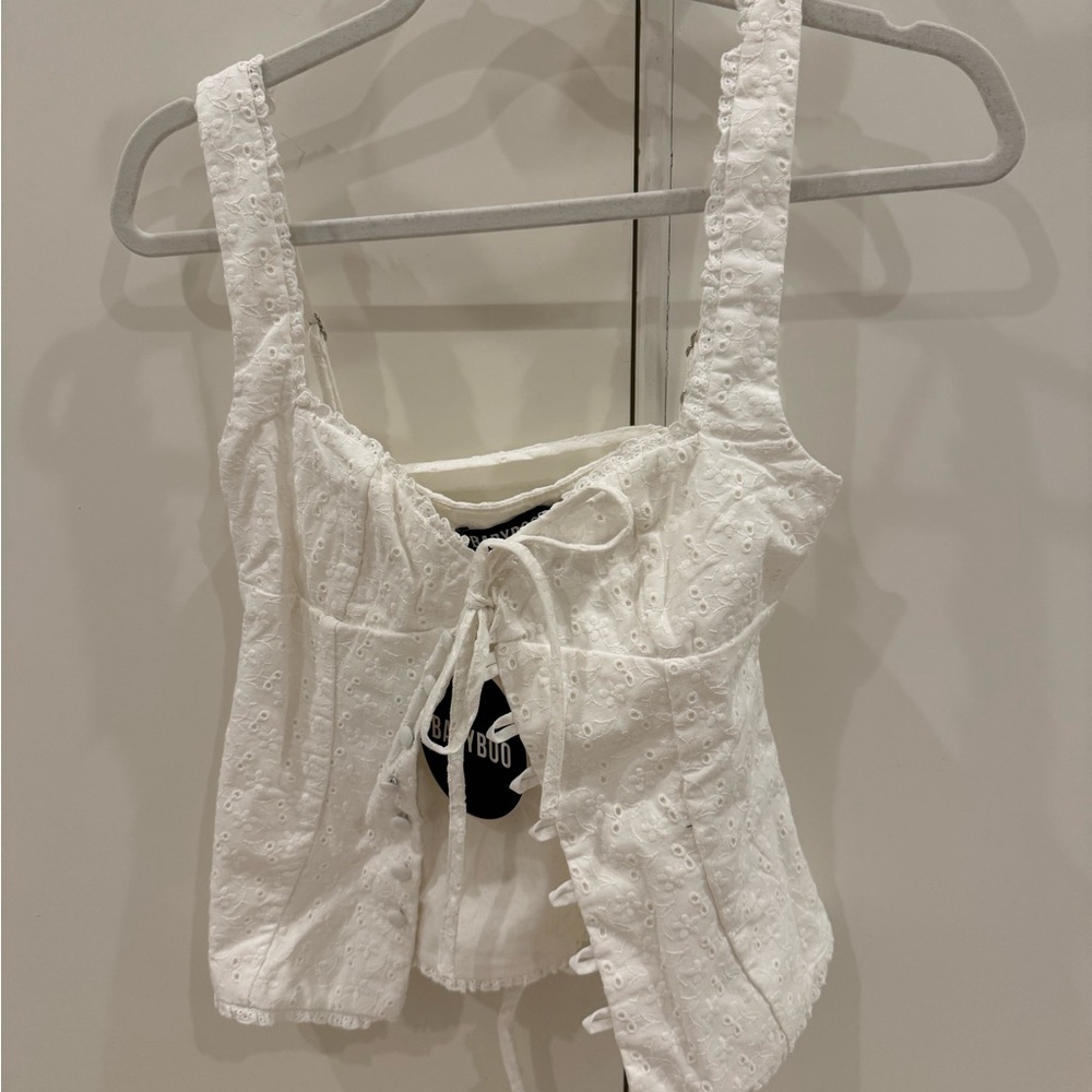 White sleeveless tank top with tie front and ruched details